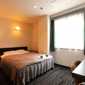 Postel nebo postele na pokoji v ubytování Comfesta Inn Kabe