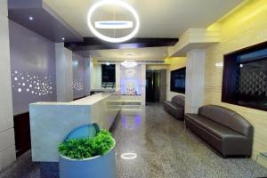 a lobby with a couch and a reception desk at Hotel Udupi Residency near Shri Krishna Mata, Udupi in Udupi