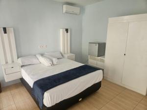 a bedroom with a bed with white sheets and pillows at Two Brothers Guesthouse in Legian +56 photos