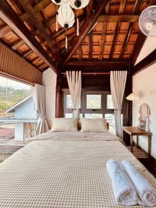 a bedroom with a large bed and a large window at The Monhi Da Lat City in Xuan An +71 photos