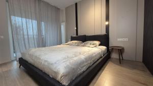 a bed in a room with a large window at Luxurious Vanilla Apartment, self check-in 24h, free parking, air-conditioning in Poznań
