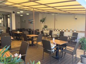 a restaurant with tables and chairs in a room at Melia Mar in Sozopol