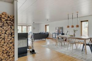 a living room with a table and a fireplace at The Copper Cottage in Löddeköpinge +19 photos