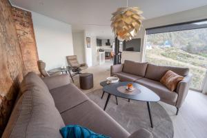 a living room with a couch and a table at Runde Panorama - Østen Pilot in Terøy