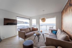 a living room with a couch and a table at Runde Panorama - Østen Pilot in Terøy
