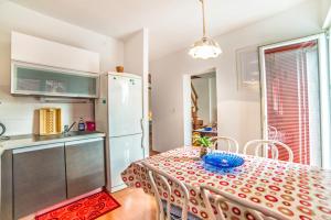 a kitchen and dining room with a table and a refrigerator at Apartment Iva in Rovinj
