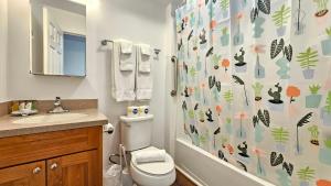 a bathroom with a toilet and a shower curtain at 2413 Kuhio in Honolulu +20 photos