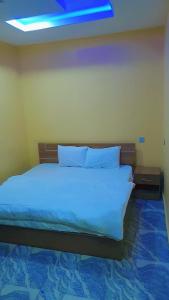 Cama o camas de una habitación en Pollyjolly Hotel And Suites