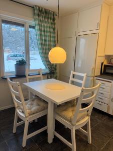 a kitchen with a table and chairs and a window at 4 bed apartment close to Branäs resort - Apoteksvägen 10A in Likenäs +10 photos