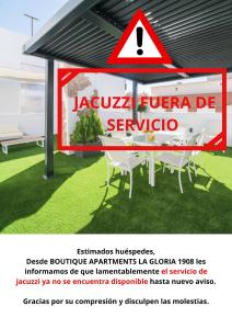a sign on a building with a table and chairs at BOUTIQUE APARTMENTS- LA GLORIA 1908 in Almería