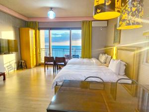a bedroom with a bed and a view of the ocean at OROJEJU in Seogwipo