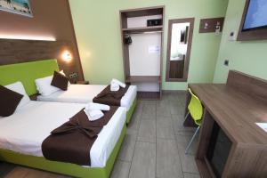 Postel nebo postele na pokoji v ubytování Hotel Giacosa