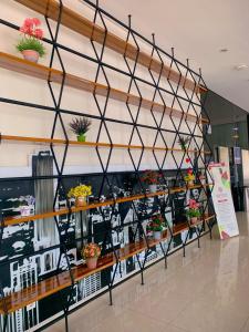 a display of potted plants on shelves in a store at Apartment Elvis Tower Cikarang in Pegadungan