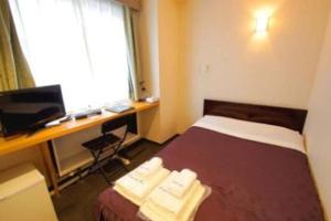 Postel nebo postele na pokoji v ubytování Comfesta Inn Kabe