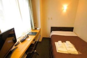 Postel nebo postele na pokoji v ubytování Comfesta Inn Kabe