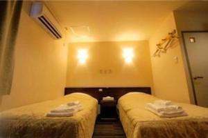 Postel nebo postele na pokoji v ubytování Comfesta Inn Kabe