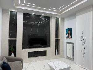 a living room with a flat screen tv on a wall at Relax assoluto in Cremona