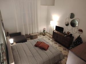 a living room with a bed and a christmas tree at Vlll PORTICO in Bologna