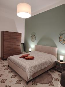 a bedroom with a bed and a dresser and two candles at Vlll PORTICO in Bologna +42 photos