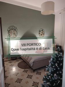 a room with a bed with a christmas tree at Vlll PORTICO in Bologna