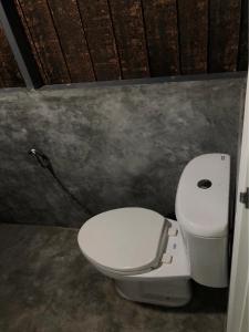 a bathroom with a white toilet in a room at The Big House in Koh Chang Ranong