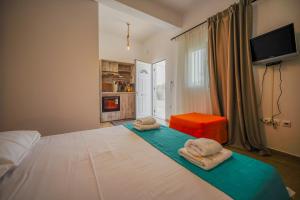 a bedroom with a bed with two towels on it at Cozy flat studio in Galaxidi
