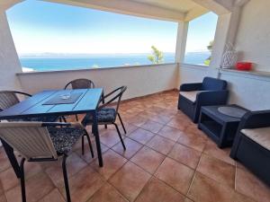 a balcony with a table and chairs and the ocean at Vila Nada in Prigradica