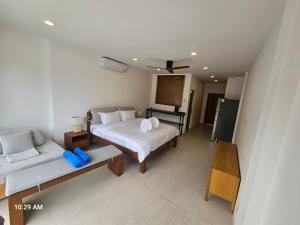 a large bedroom with a bed and a couch at 8 Bedroom Monkey Villa Room 201 in Amphoe Koh Samui