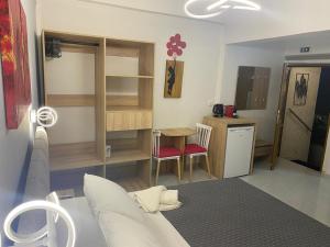 a living room with a couch and a table and a kitchen at Cosy studio 2 in Stoupa in Stoupa