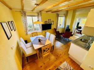 a kitchen and dining room with a table and chairs at Familienchalets am Millstätter See in Rothenthurn