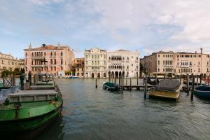a group of boats docked in a canal with buildings at Dimora Capuleti in Venice