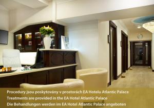 a room with a desk and chairs in a hotel room at EA Hotel Elefant in Karlovy Vary