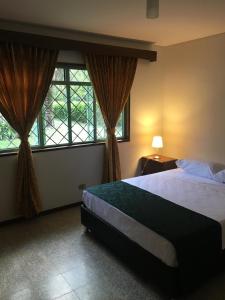 a bedroom with a large bed and two windows at Finca Jerusalen in Tobia