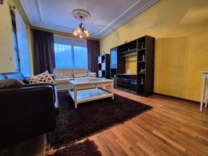 a living room with a couch and a coffee table at Casa Marisol Blue 36A02 in Pola de Laviana