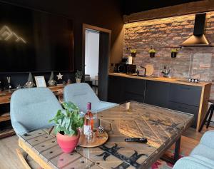 a kitchen with a table and chairs and a counter at Casa Larisa Antonia Apartments in Sinaia
