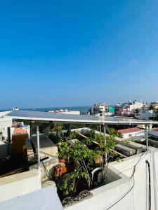 a view of the ocean from the roof of a building at La Villa Marseille in Puducherry +63 photos