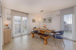 a dining room with a table and chairs at Ferienhaus Adele in Ueckeritz