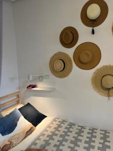 a bedroom with hats on the wall and a bed at Casa del Sombrero Los Locos beach in Torrevieja