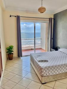 a bedroom with a bed and a view of the ocean at Please add me - Plus One 514 six six two 5576 - Villa Paradise Beach - Sidi Bouzid - Ocean Sunset Views & Pools in Douar Ourlali +35 photos