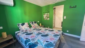 a bedroom with a bed with a green wall at Chambres d'hôtes Les Nymphéas in Revest-les-Roches +36 photos