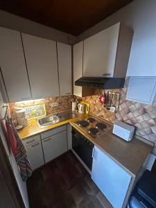 a small kitchen with a sink and a stove at Ferienwohnung Schömberg in Schömberg