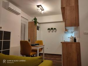 a small kitchen with a table and a refrigerator at Studio apartman Cezar apartmani Borik in Bjelovar