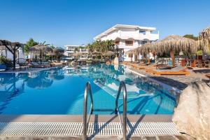 a swimming pool with chairs and umbrellas at a resort at Aquarius Beach Hotel in Faliraki