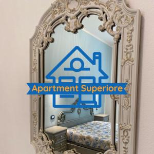 a bedroom with a mirror with the words appointment superhero at Apartment Superior 950 Meters From The Sea in Albisola Superiore