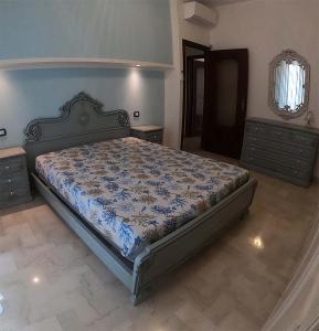 a bedroom with a bed with a blue comforter at Apartment Superior 950 Meters From The Sea in Albisola Superiore