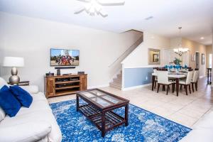 a living room with a white couch and a table at Five Bedrooms Home with Pool 4851 in Kissimmee