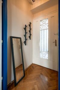 a mirror in a room with a door and a window at Decebal Modern Studio - Central Arad in Arad