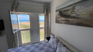 a bedroom with a bed and a window at Beachfront apartment in La Mata in La Mata
