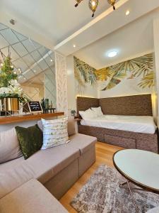 a living room with a couch and a bed at B&C Staycation by SMDC Cheer Residence in Lias +39 photos