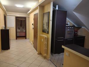 a kitchen with black cabinets and a tile floor at Ale Sweet Home in Piossasco